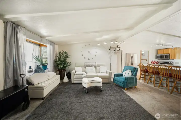 Another view of the living room and kitchen showing the open space, great for entertaining.