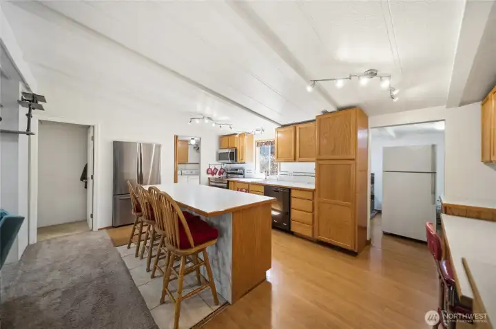 Spacious kitchen with island, breakfast bar, plenty of cabinets, built-in pantry, and a built-in desk area.