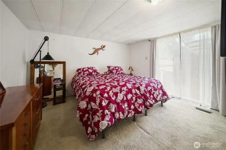 Primary bedroom with slider leading out to a private deck.