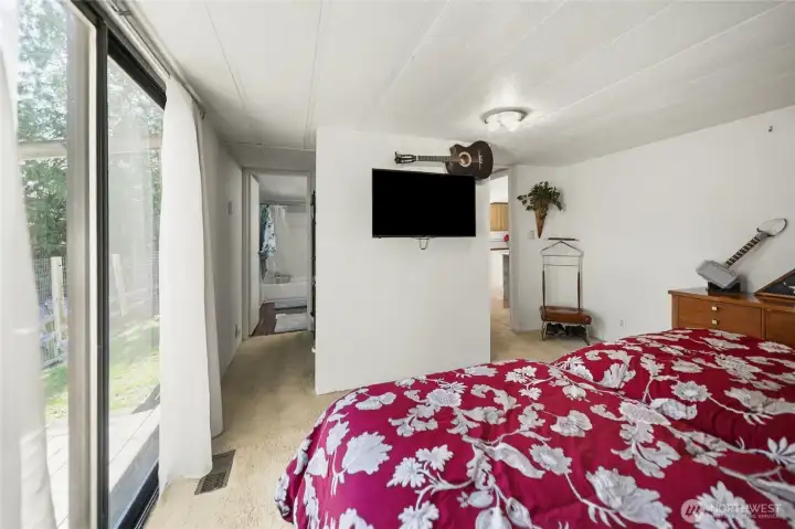 Another view of the primary bedroom showing the attached full bathroom.