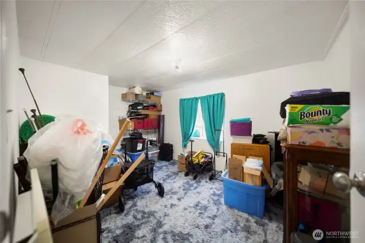 Third bedroom shown with belongings.