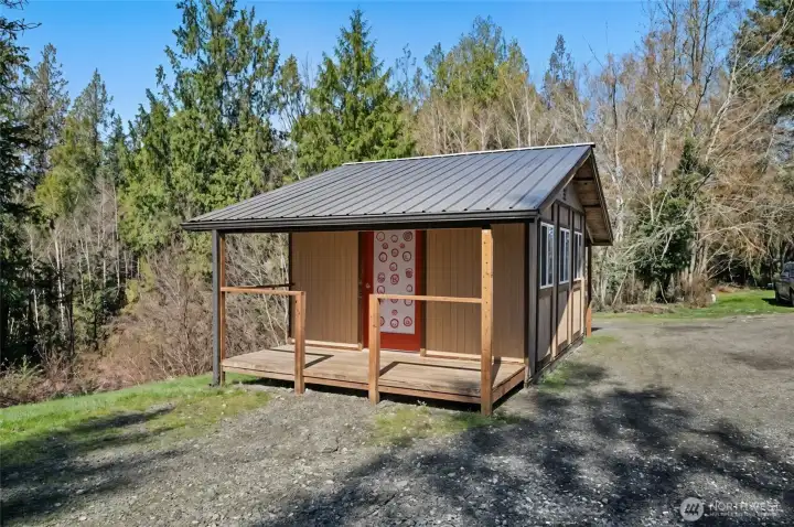 Spacious shed/shop with power, shown staged without belongings in front.