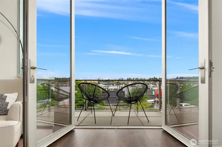 Large glass doors open to deck off living room