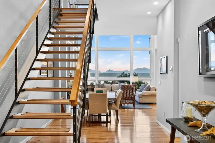 Floor-to-ceiling glass fills the entry with sweeping views of Puget Sound.