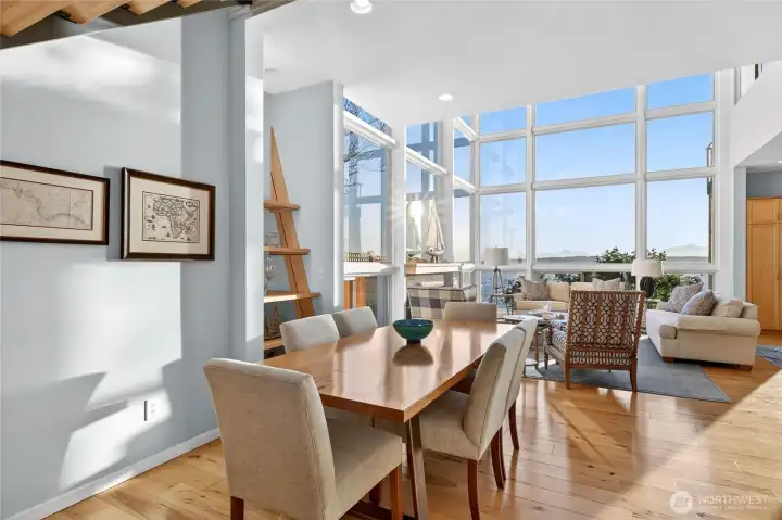 The open dining area flows naturally into the living space, all framed by water views.