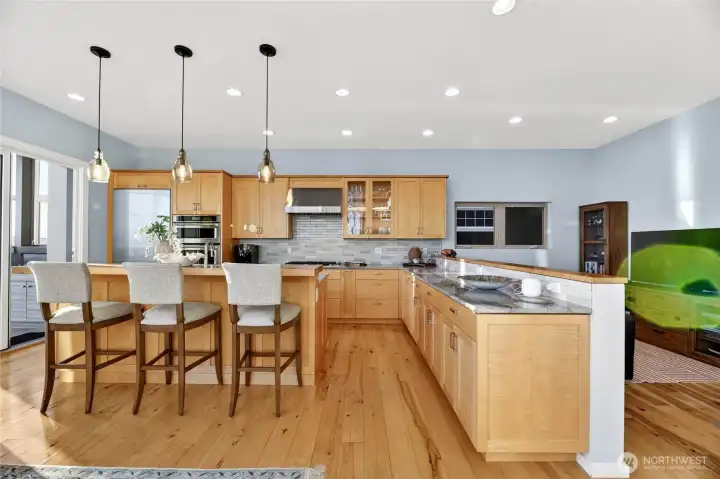 The kitchen delivers high-end appliances, custom cabinetry, and generous storage, with a cozy den just steps away.