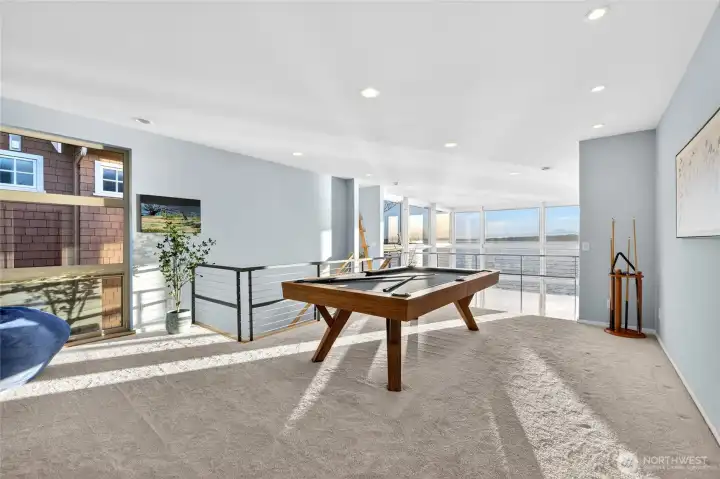 The upper-level family room offers generous space for relaxing or game nights.