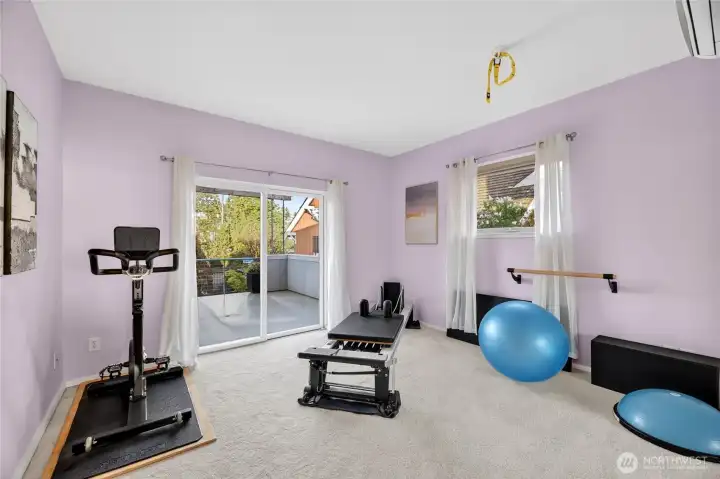 The second east-facing bedroom, also opening to the patio via sliding doors, is currently used as an exercise room.