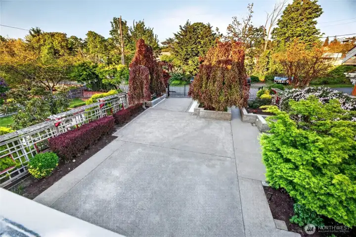 The upper patio looks out over the gated front yard and driveway.