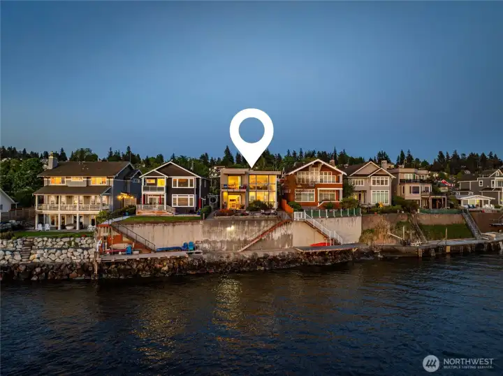An aerial view shows the property's remarkable position directly on Puget Sound.