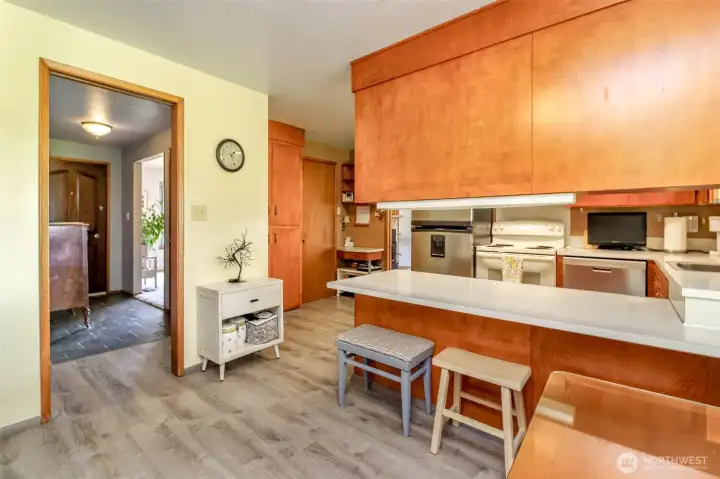 Combined dining room and kitchen with a built-in kitchen pantry and closet that houses the homes forced air furnace.
