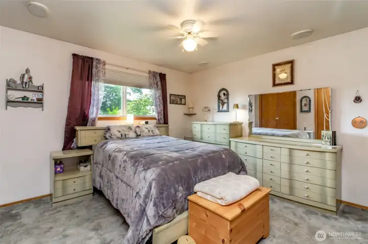 Primary bedroom overlooks the beautiful backyard.