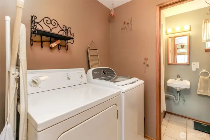 Big laundry room has a storage closet and a closet housing the hot water tank that cant be seen in the photo.