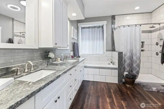 Primary bathroom offers double sinks, bathtub, and walk in shower.