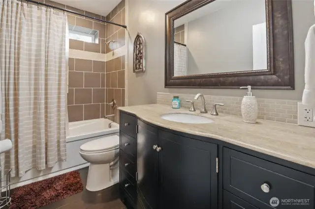 Bathroom is downstairs is located between the two bedrooms.