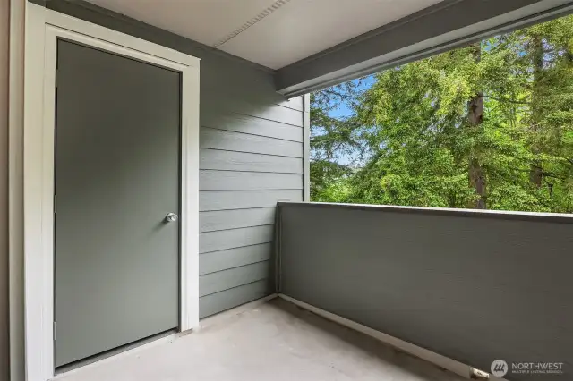 Private, covered balcony with additional storage closet.