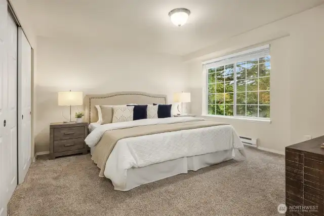 Primary bedroom with ample natural light, space, and storage.
