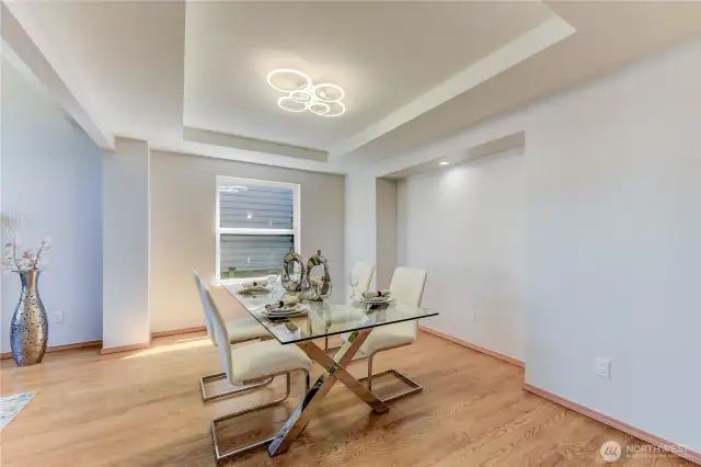 The formal dining area seamlessly opens to the living room, creating an airy, connected space ideal for both intimate dinners and larger gatherings.