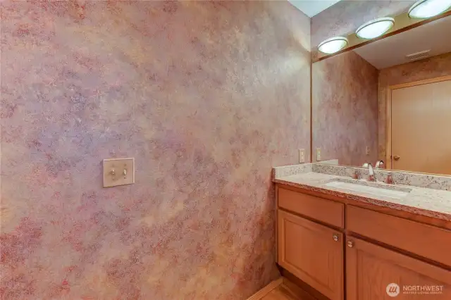 A powder room is conveniently located on the main level, perfect for guests and everyday use