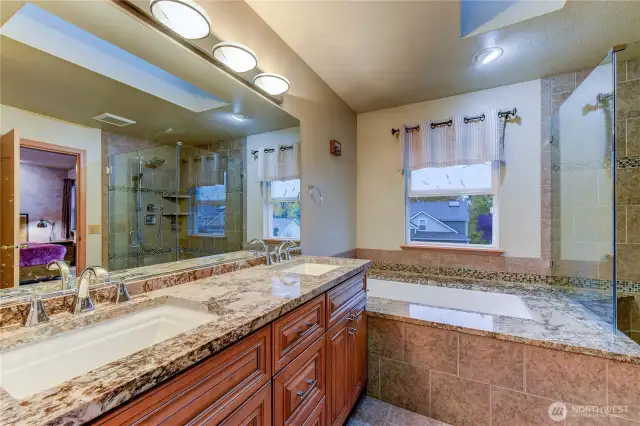The en-suite bathroom features a dual-sink vanity, soaking tub, separate shower