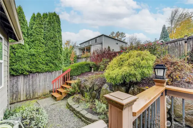 The backyard offers a peaceful outdoor escape, complete with a spacious deck—perfect for barbecues, relaxing in the sun, or entertaining guests in a private, serene setting.