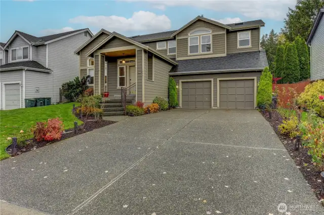 In front of the spacious 560 sq ft two-car garage, there is ample parking available for additional vehicles.