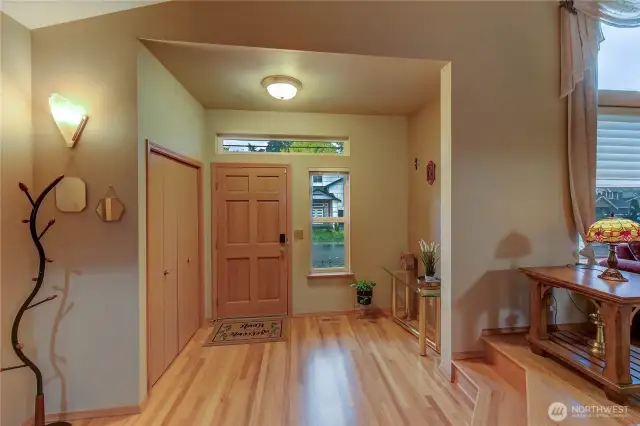 From the living room, enjoy a clear view of the welcoming entryway, which features a convenient coat closet and sets the tone with its thoughtful layout and seamless flow into the main living space.