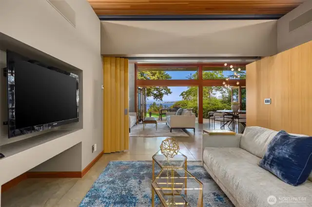 Flexible media or office room with custom built-ins and slidding doors doors for privacy