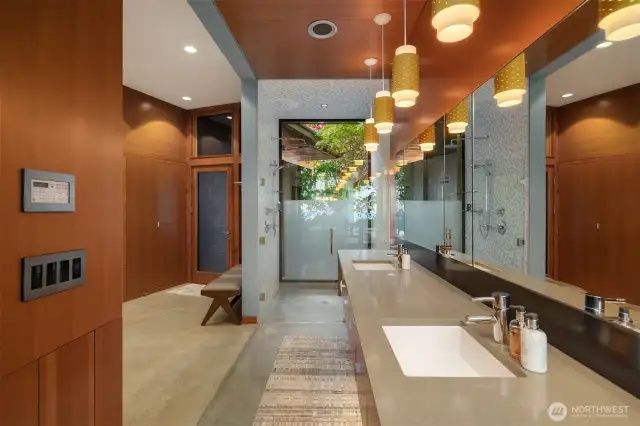 Floating vanity, walk-in glass shower, and integrated laundry.