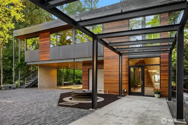 Sleek concrete, metal, and IPE wood define the modern exterior.