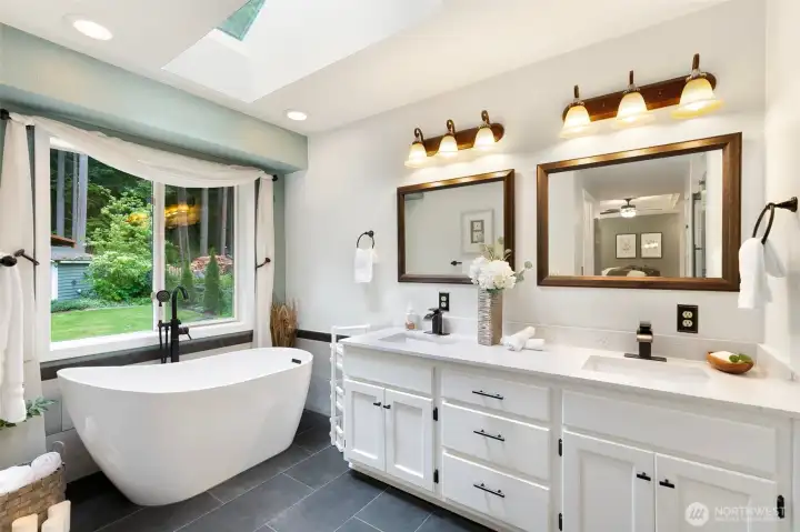 Spa like primary bath facing lush back yard