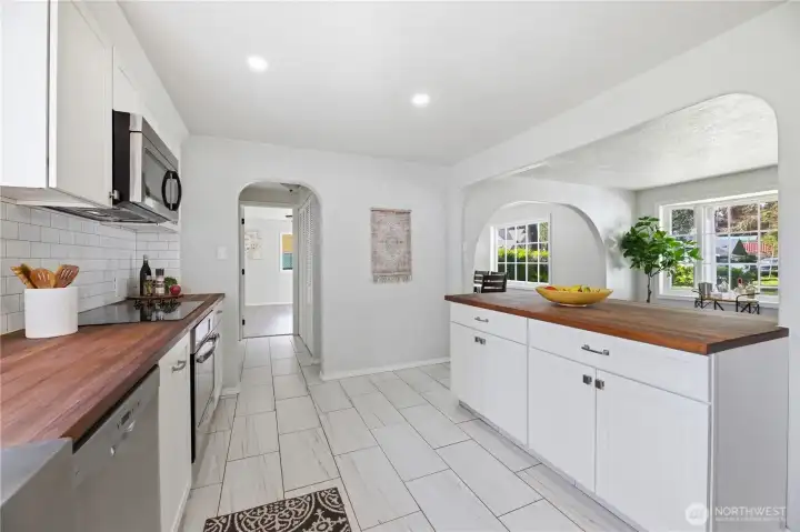 Updated kitchen with coved passthroughs adding so much charm to this bright and open space