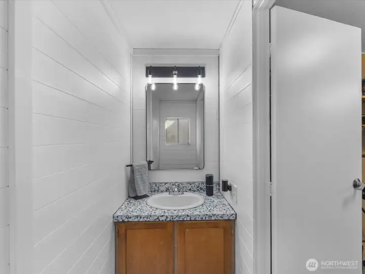 Refreshed 1/2 bath off laundry room with easy access to back deck.