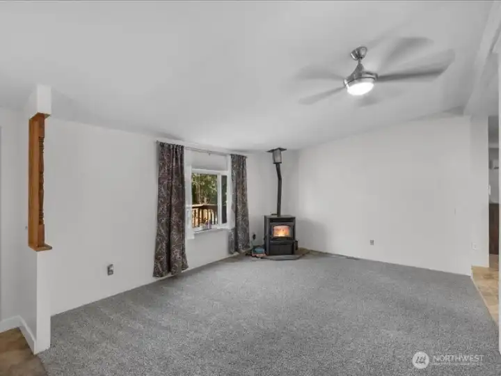 Living room with Lopi pellet stove and new carpet.