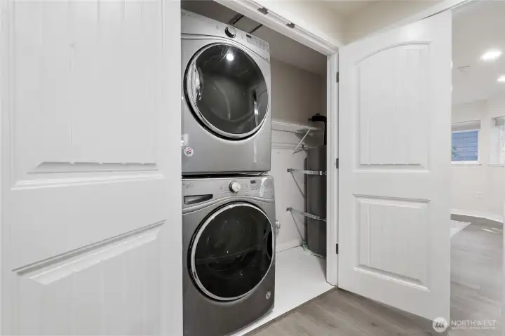 Laundry closet with additional storage.