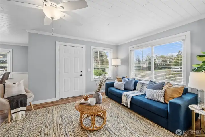 Inviting living room with updated laminate wood flooring throughout for a cohesive, modern look