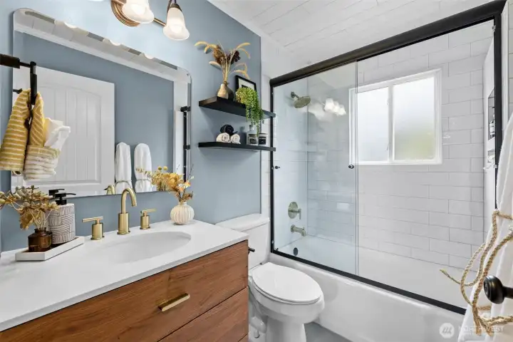 Crisp tile surround + glass enclosure for a spa-like feel