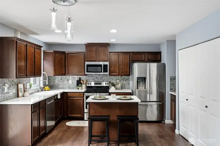 Kitchen with eat up island, pantry to the right.