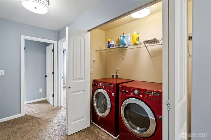 Upstairs laundry located between bedrooms.