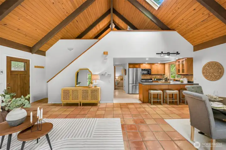 Bright living room with soaring ceilings, exposed beams, and abundant natural light. Bright living room with soaring ceilings, exposed beams, and abundant natural light.