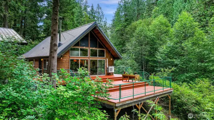 The 1400+SF deck overlooks the creek and is the perfect place to unwind or entertain. The 1400+SF deck overlooks the creek and is the perfect place to unwind or entertain.