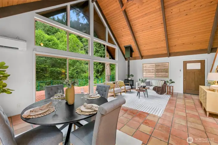 Floor-to-ceiling windows fill the great room with natural light while framing peaceful forest views. Floor-to-ceiling windows fill the great room with natural light while framing peaceful forest views.