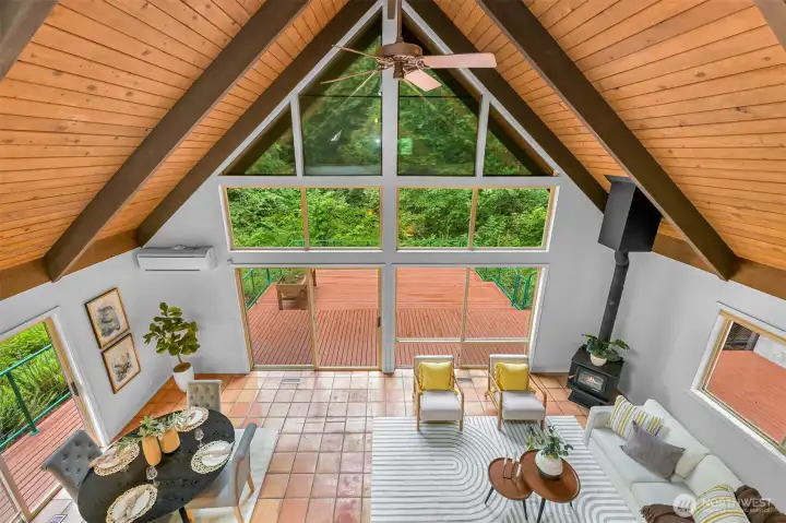 The spacious loft showcases dramatic cedar ceilings and skylights while offering room for multiple living or recreation spaces. The spacious loft showcases dramatic cedar ceilings and skylights while offering room for multiple living or recreation spaces.