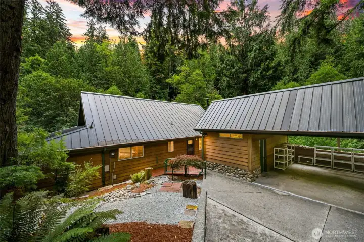 Covered parking connects conveniently to the home while blending seamlessly into the surrounding landscape. Covered parking connects conveniently to the home while blending seamlessly into the surrounding landscape.