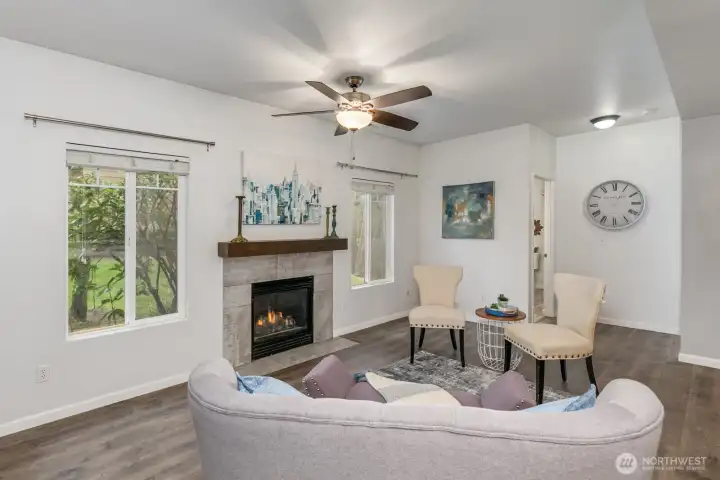 Light-filled living room with vaulted ceilings and cozy gas fireplace.