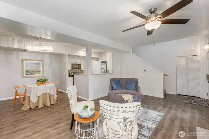 Open-concept living and dining area with durable laminate flooring.
