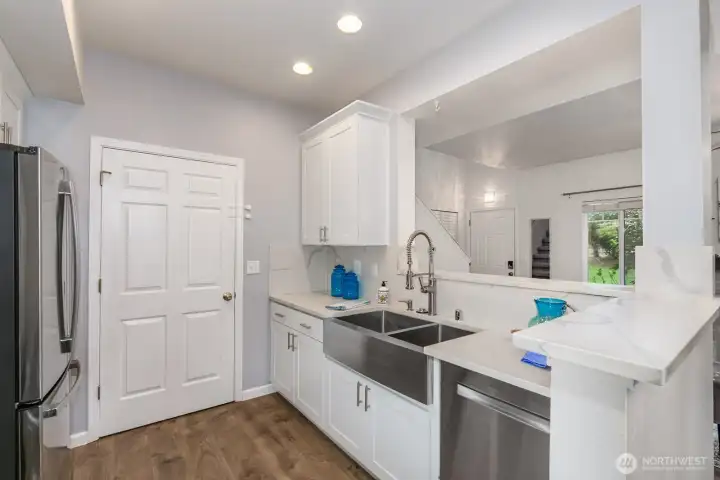 Bright kitchen with stainless steel appliances and ample cabinet storage.