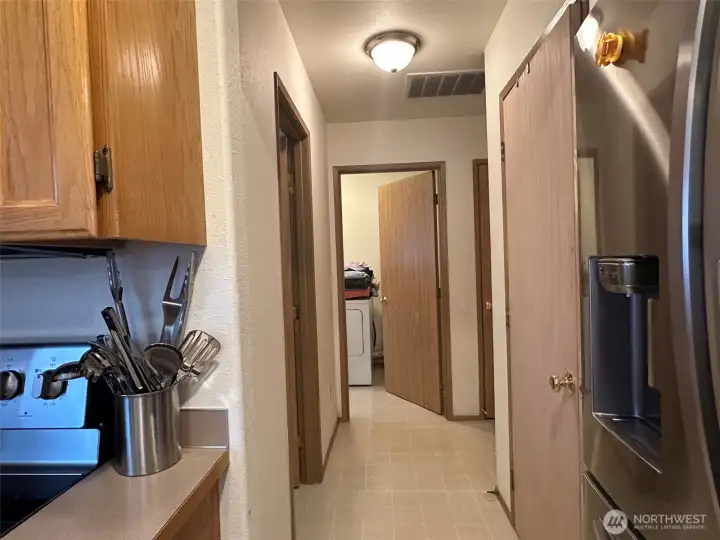 Functional hallway w/easy access to utility room, powder room, and garage. Functional hallway w/easy access to utility room, powder room, and garage.