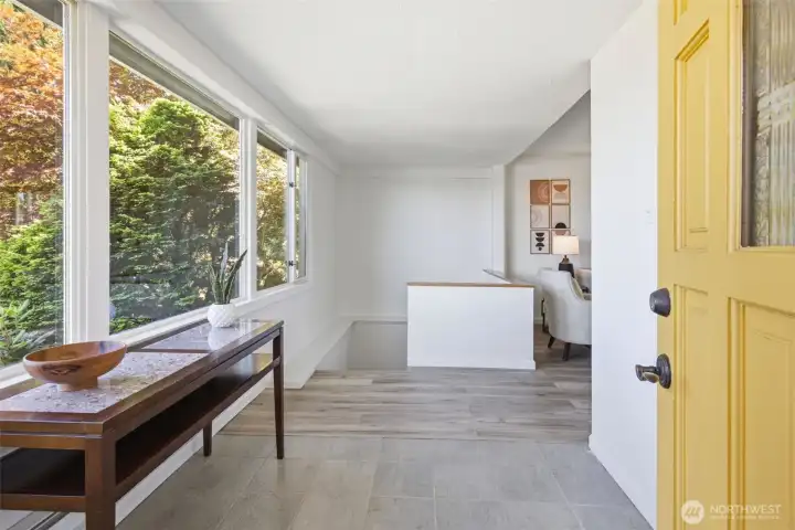 Welcome to an inviting entryway that offers a convenient, dedicated space for removing coats and shoes.