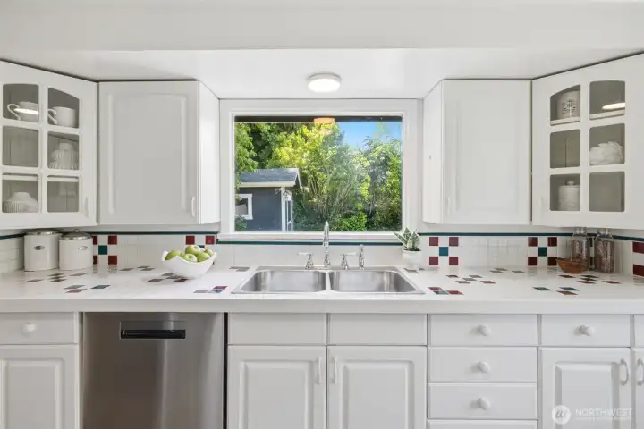 Bright, natural light fills this space, which offers a picturesque view of the lush, private backyard.